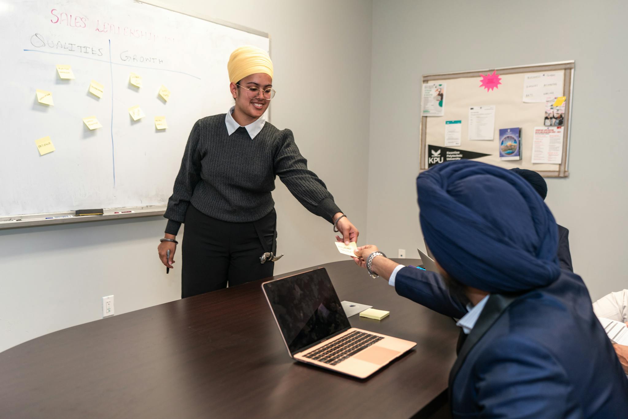 Business professionals engage in a collaborative meeting around a conference table, sharing ideas and strategies.
